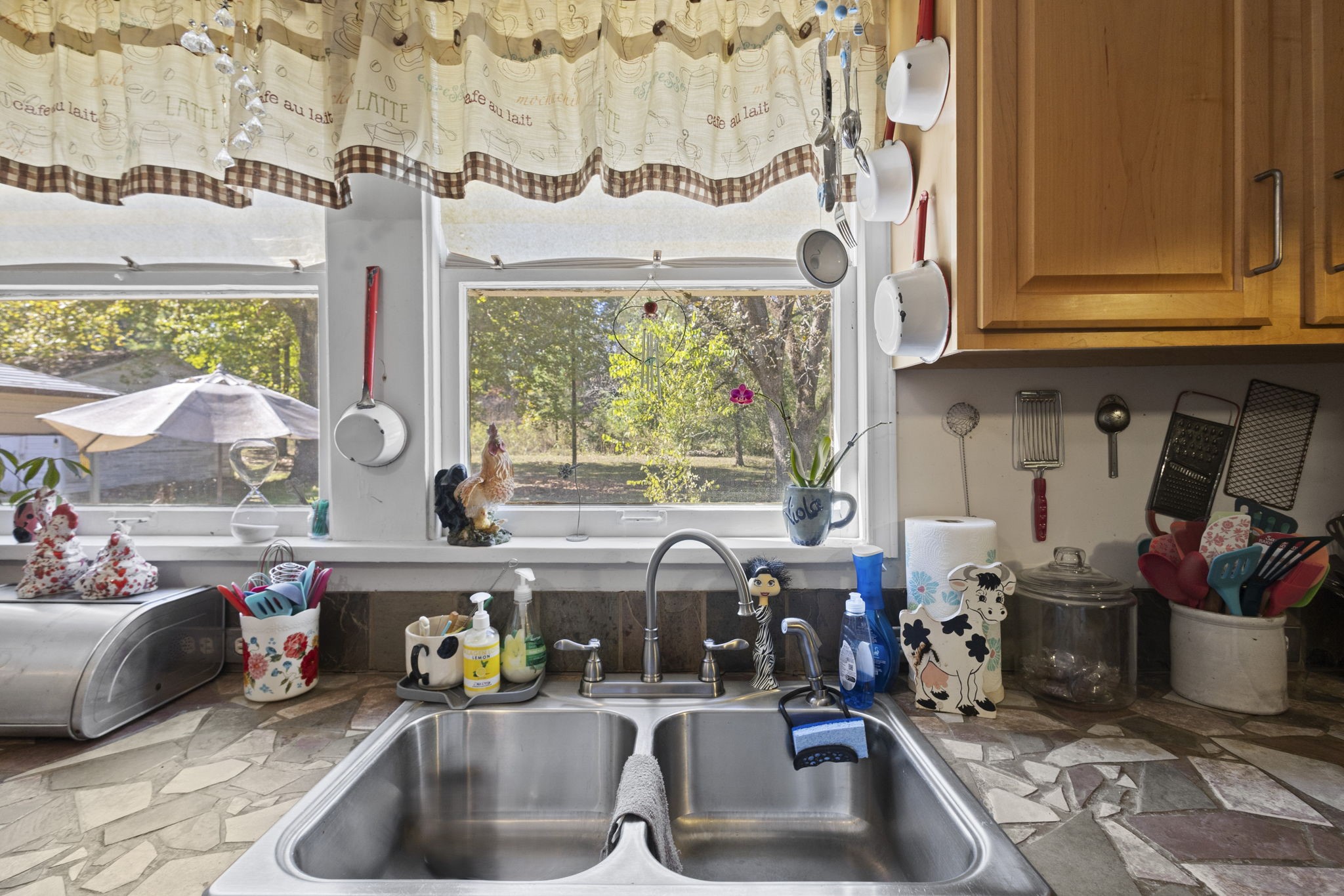 105 Mann Street Colmesneil, TX 75938 - Photo 27 of 40 a kitchen with a sink and a stove next to a window