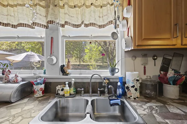 a kitchen with a sink and a stove next to a window