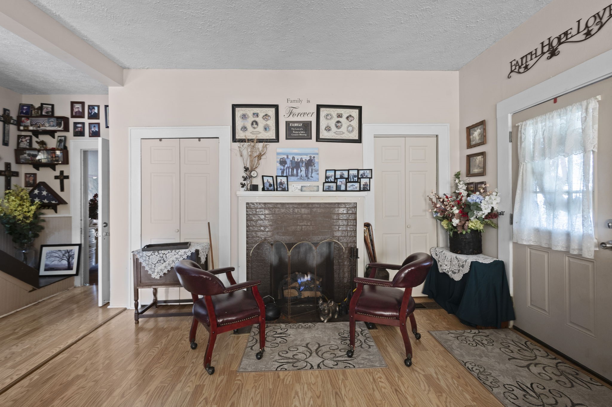 105 Mann Street Colmesneil, TX 75938 - Photo 3 of 40 a living room with furniture and a fireplace