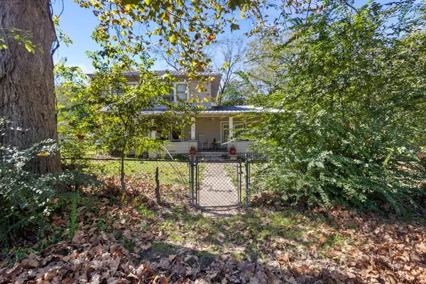 a balcony with table and chairs and a tree