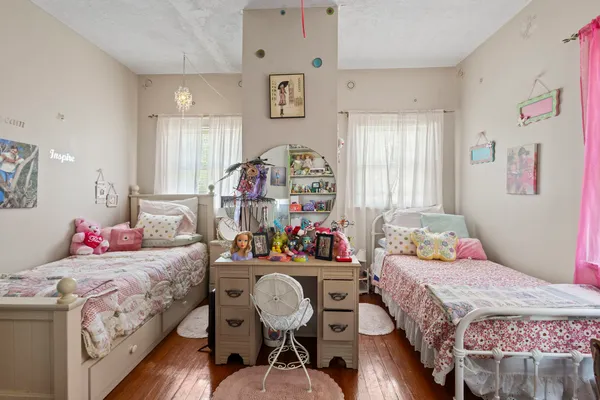 a bedroom with bed and a furniture