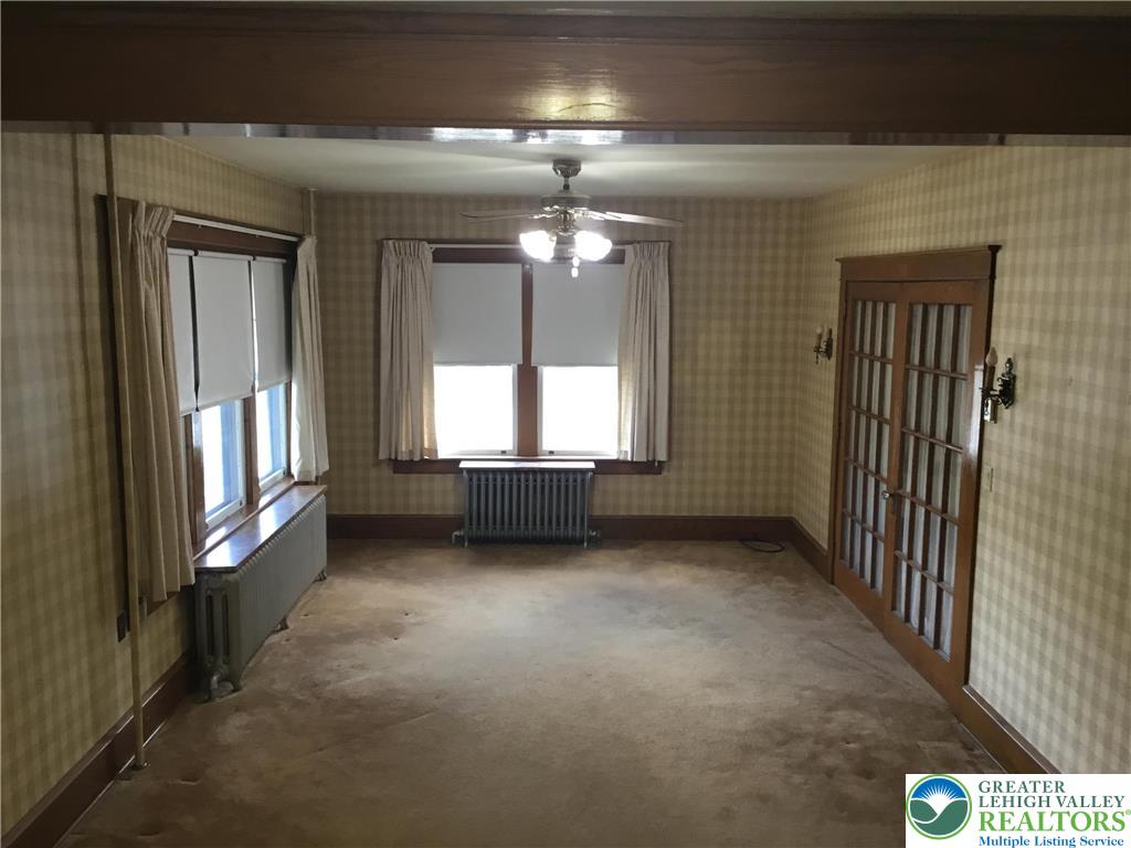 1105 Main Street Slatington, PA 18080 - Photo 6 of 31 A well-lit interior space awaits with large windows, an overhead ceiling fan, and French doors.