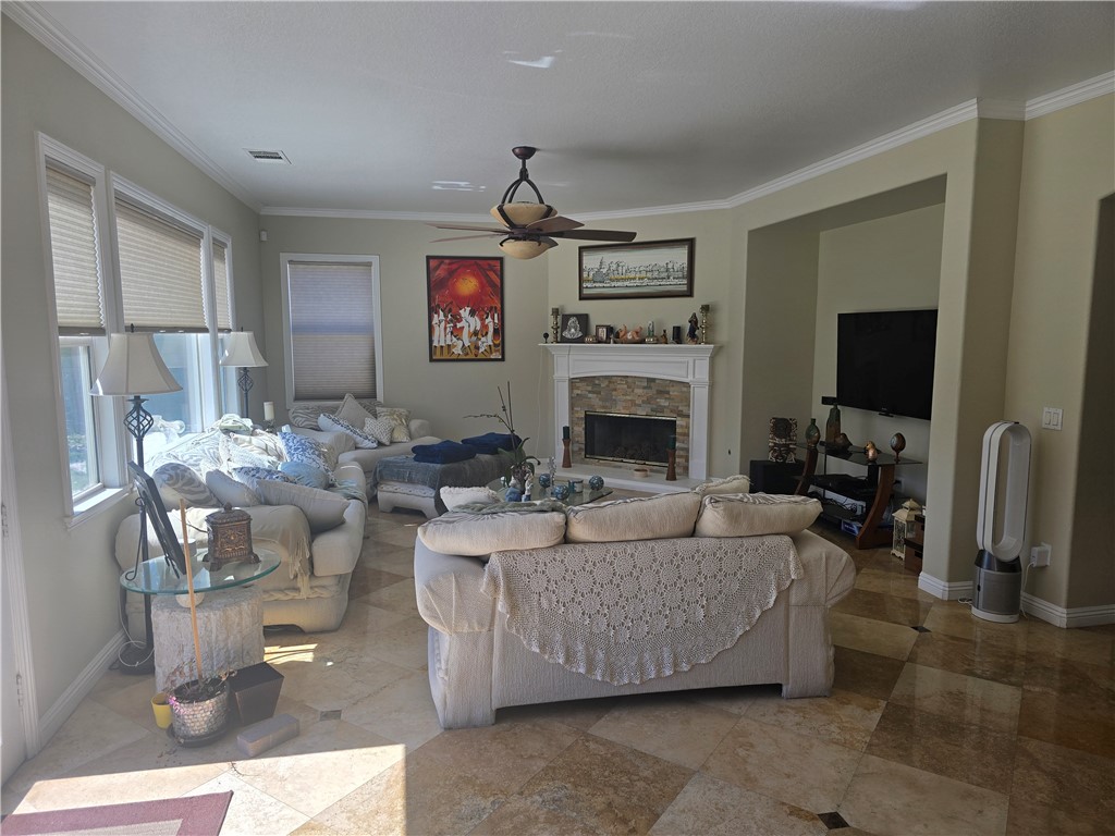 41740 Firenze Street Lancaster, CA 93536 - Photo 15 of 53 a living room with couches a flat screen tv and a fireplace