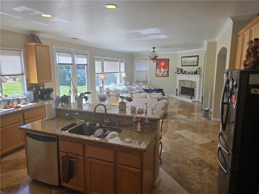 41740 Firenze Street Lancaster, CA 93536 - Photo 18 of 53 a kitchen with stainless steel appliances granite countertop a sink a stove and a refrigerator