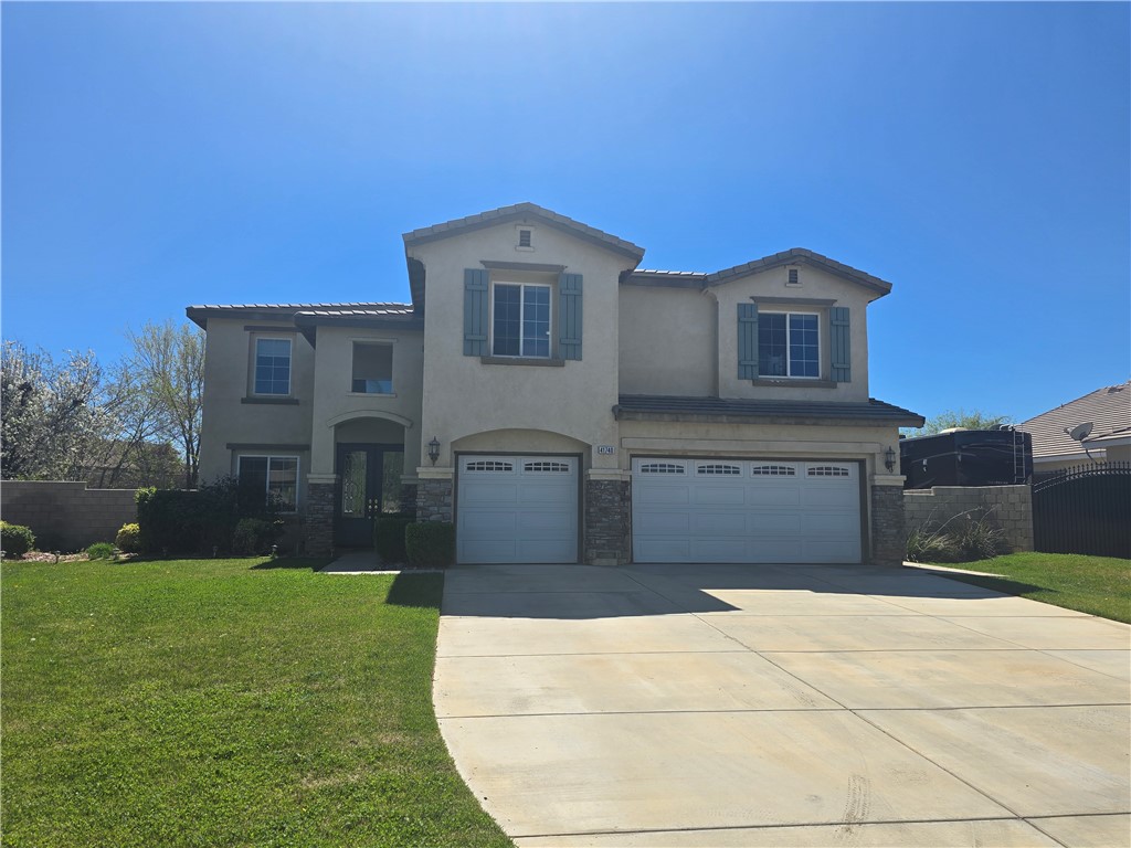 41740 Firenze Street Lancaster, CA 93536 - Photo 2 of 53 a front view of a house with garden