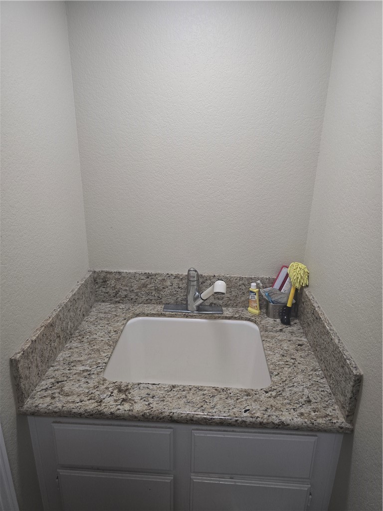 41740 Firenze Street Lancaster, CA 93536 - Photo 27 of 53 a bathroom with a granite countertop sink and vanity