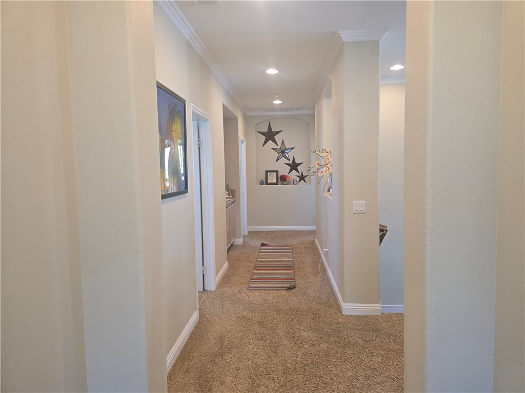 41740 Firenze Street Lancaster, CA 93536 - Photo 29 of 53 a view of a hallway with wooden floor and a bathroom