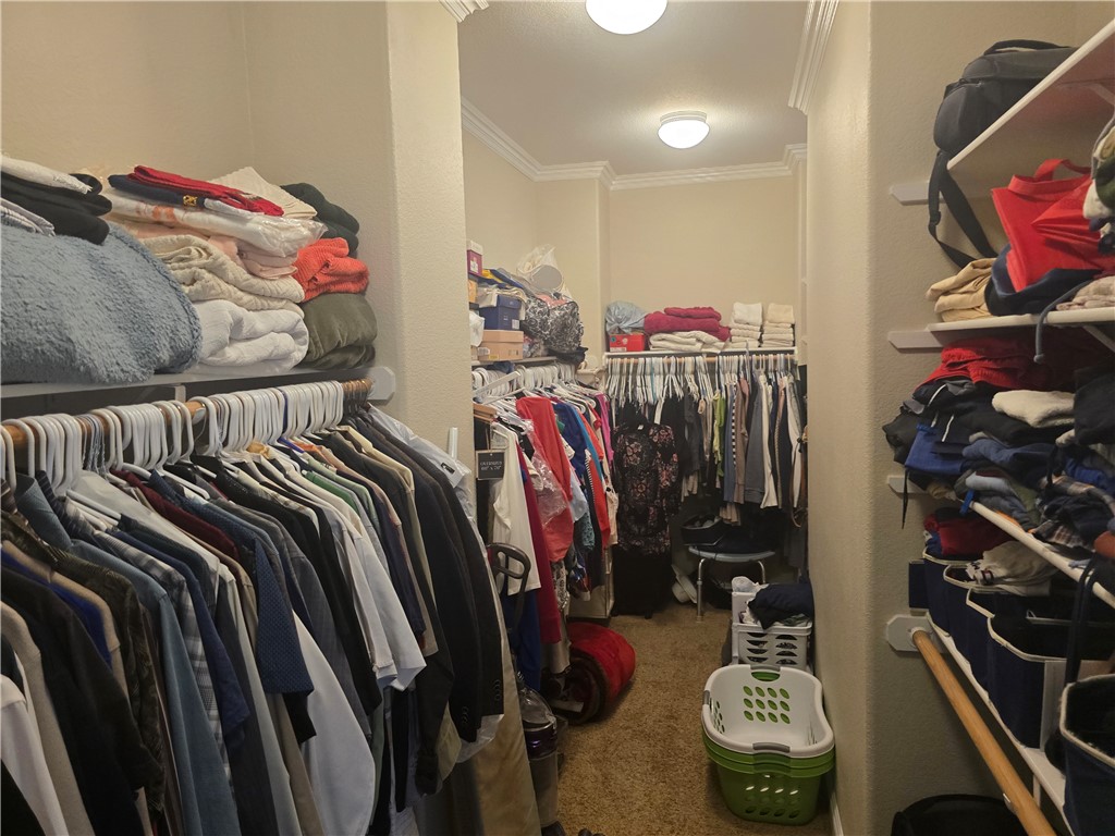 41740 Firenze Street Lancaster, CA 93536 - Photo 39 of 53 a view of walk in closet with clothes and shoes