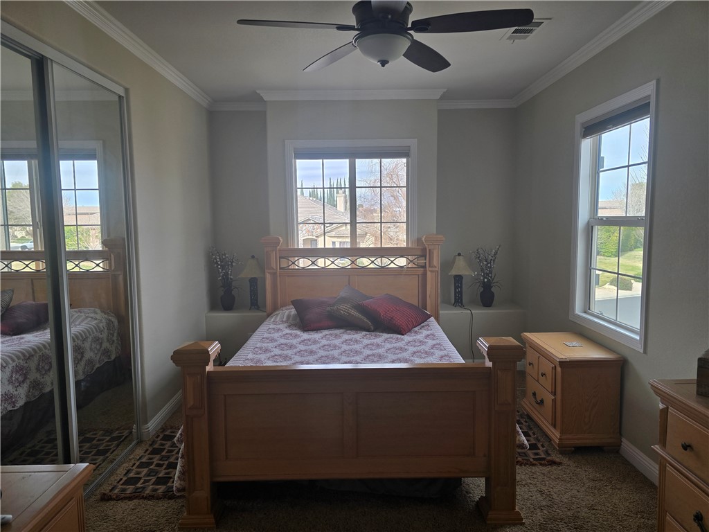 41740 Firenze Street Lancaster, CA 93536 - Photo 44 of 53 a bedroom with a bed and a window