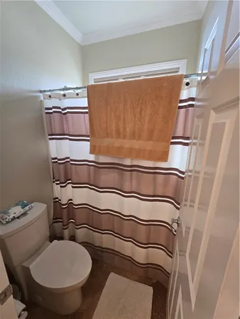 a bathroom with a granite countertop sink a toilet and mirror