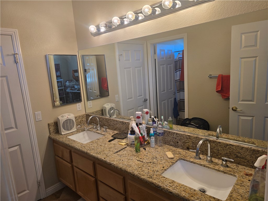41740 Firenze Street Lancaster, CA 93536 - Photo 47 of 53 a bathroom with a granite countertop double vanity sink and a mirror