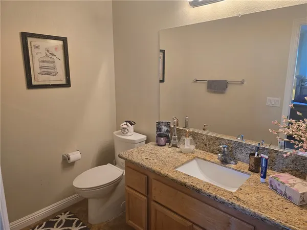 a spacious bedroom with a bed and a dresser in it
