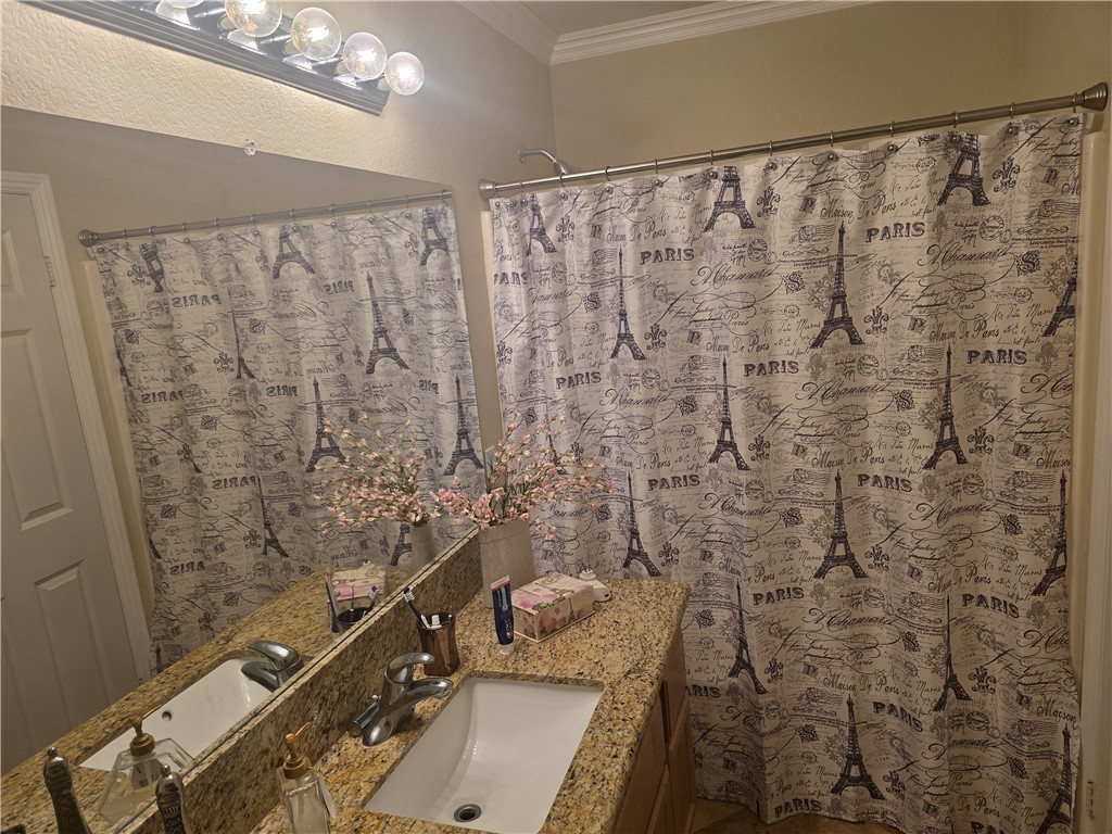 41740 Firenze Street Lancaster, CA 93536 - Photo 49 of 53 a bathroom with a shower curtain and a sink