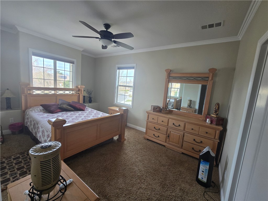 41740 Firenze Street Lancaster, CA 93536 - Photo 50 of 53 a spacious bedroom with a bed and a dresser in it