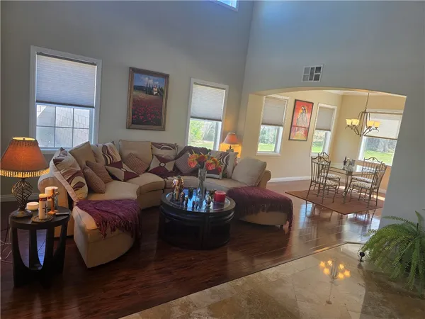 a living room with furniture window and wooden floor