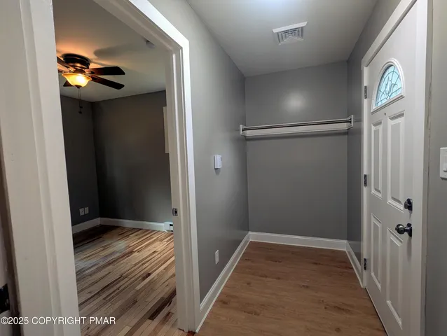 a view of hallway with wooden floor