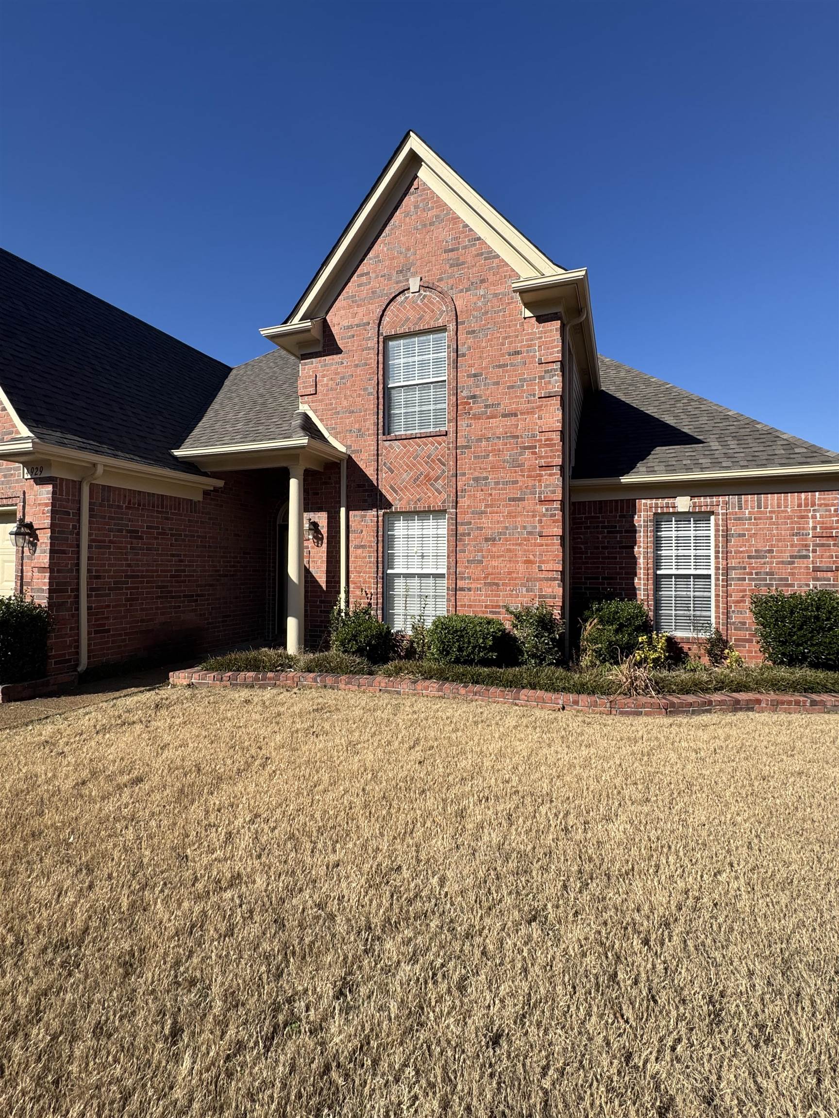 4929 Whitfall Cove South Memphis, TN 38125 - Photo 3 of 22 a front view of a house with a yard