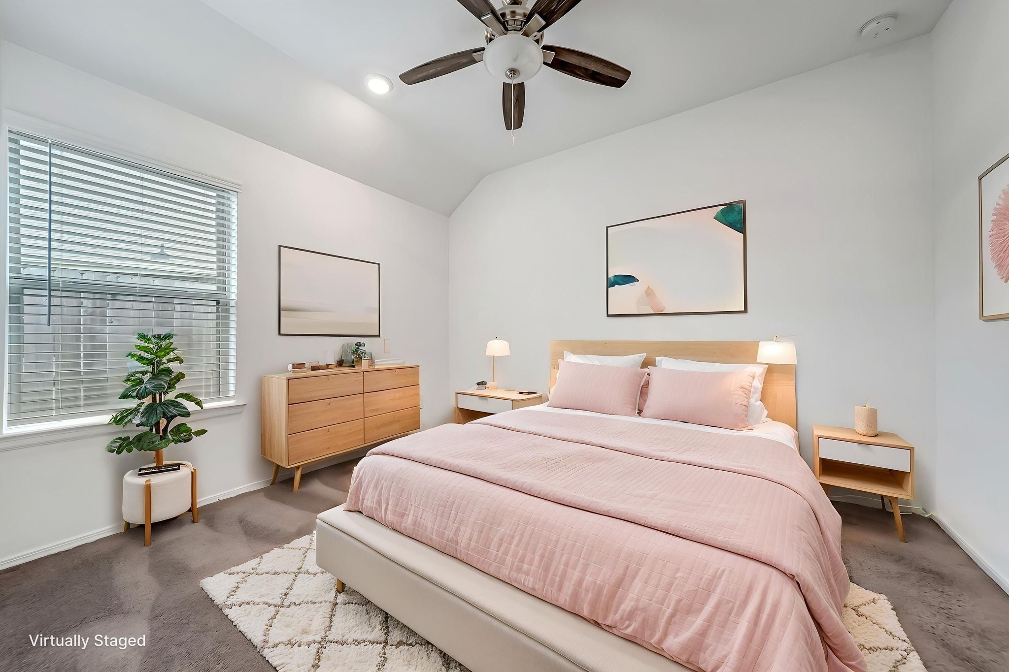 2847 Mistygate Court Conroe, TX 77301 - Photo 10 of 27 This virtually staged bedroom features a cozy, modern design with soft pink bedding, light wood furniture, and a ceiling fan. Natural light fills the space through a large window, enhancing the clean, minimalist decor.