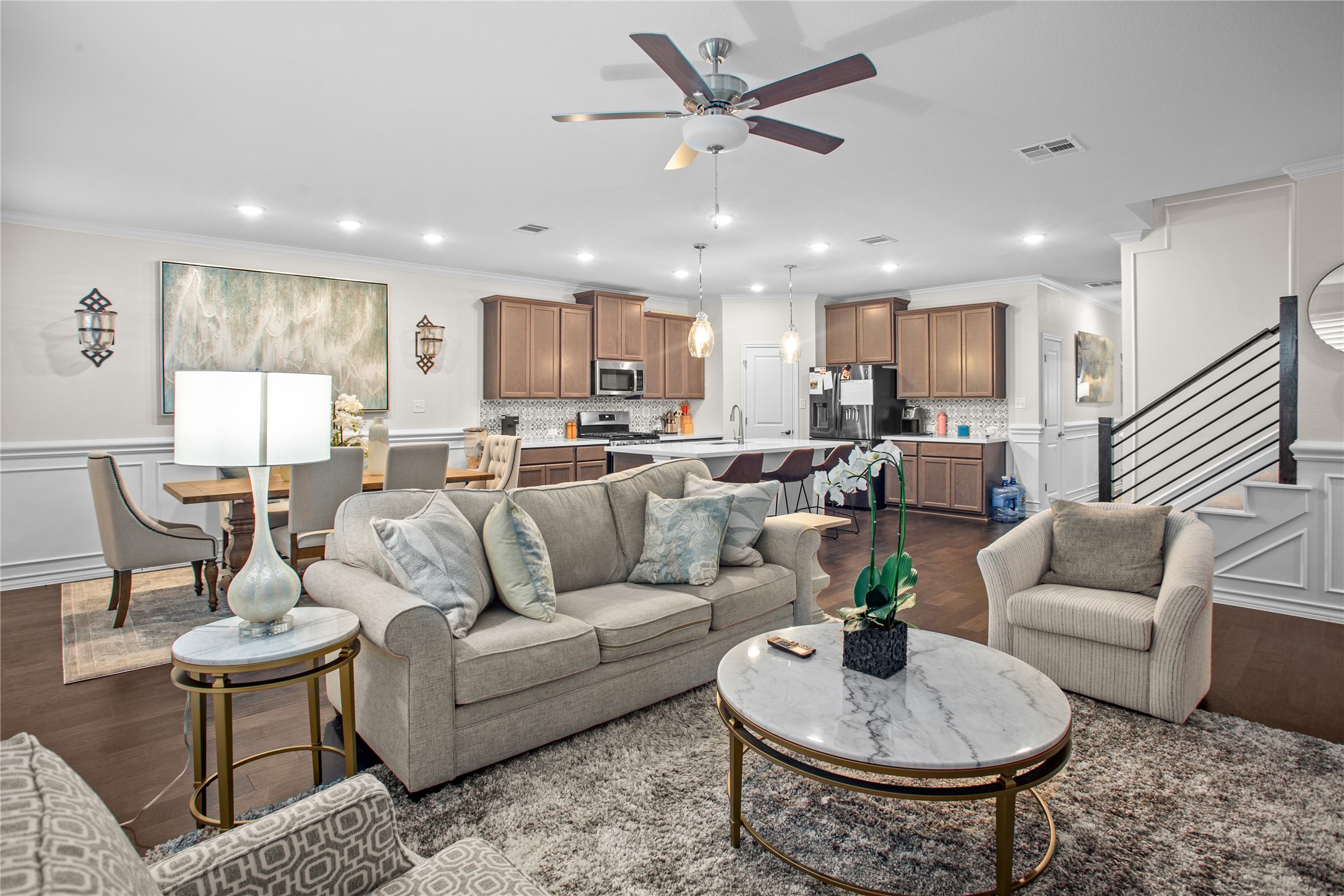 109 Adeline Road Hutto, TX 78634 - Photo 10 of 40 Living room with wainscoting, a decorative wall, dark wood-style floors, a ceiling fan, and recessed lighting