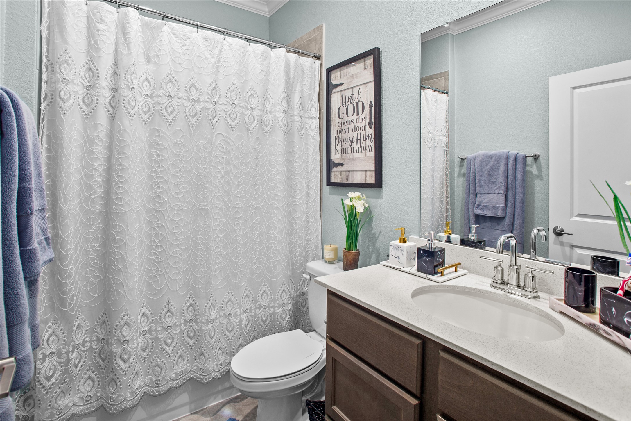 109 Adeline Road Hutto, TX 78634 - Photo 25 of 40 Full bath with a textured wall, vanity, and ornamental molding
