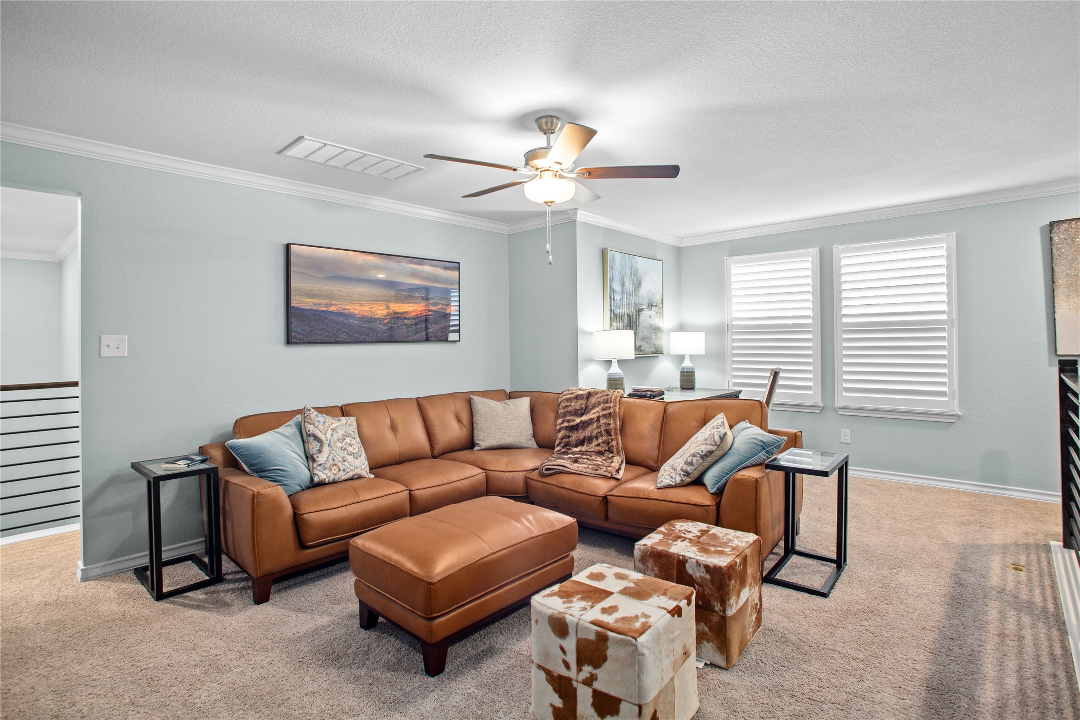 109 Adeline Road Hutto, TX 78634 - Photo 37 of 40 Carpeted living area with crown molding and ceiling fan