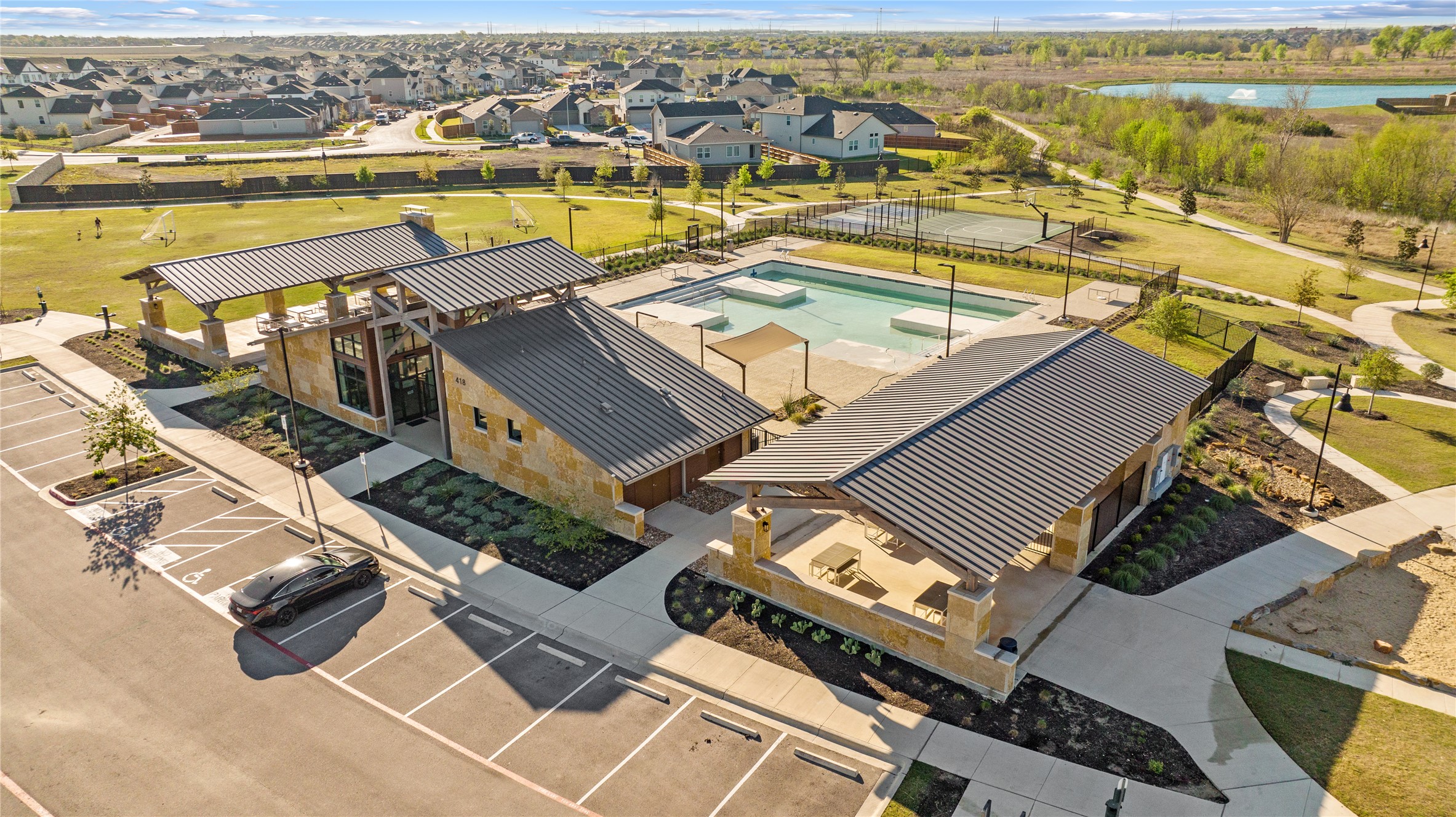 109 Adeline Road Hutto, TX 78634 - Photo 38 of 40 Aerial perspective of suburban area featuring a large body of water and a pool