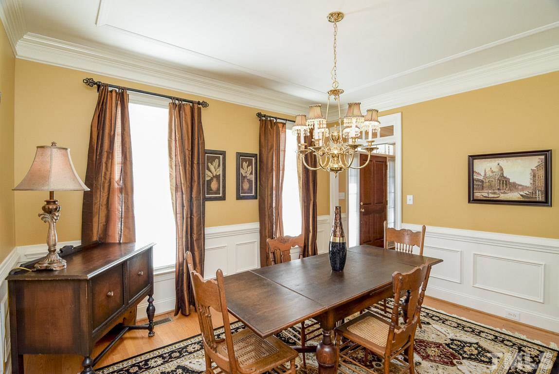 2400 Eddystone Road Raleigh, NC 27612 - Photo 8 of 25 Elegant Dining with Extensive Trim Work, Wainscoting, Hardwood Floors, and Lots of light!