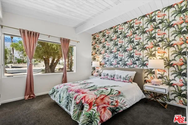 a bedroom with a large bed and a window