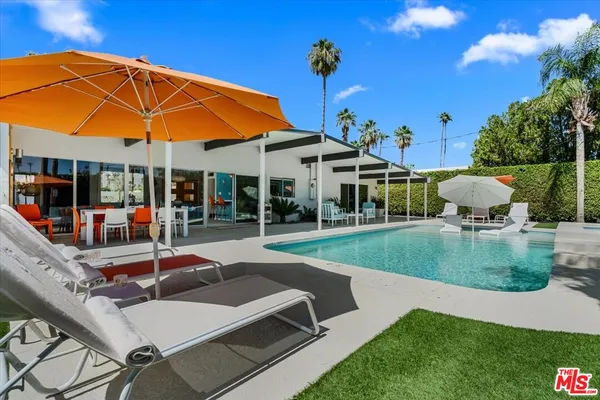 a view of a patio with table and chairs and potted plants