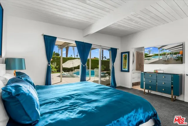 a spacious bedroom with a bed and a large window