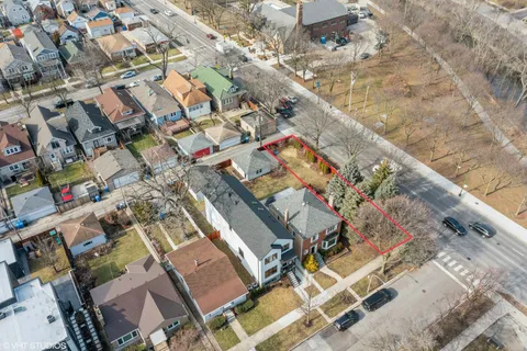 an aerial view of a house with a yard