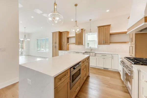 a kitchen with a stove a sink and a refrigerator