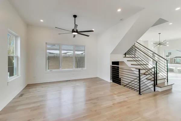 a view of a living room a ceiling fan hardwood floor and a ceiling fan