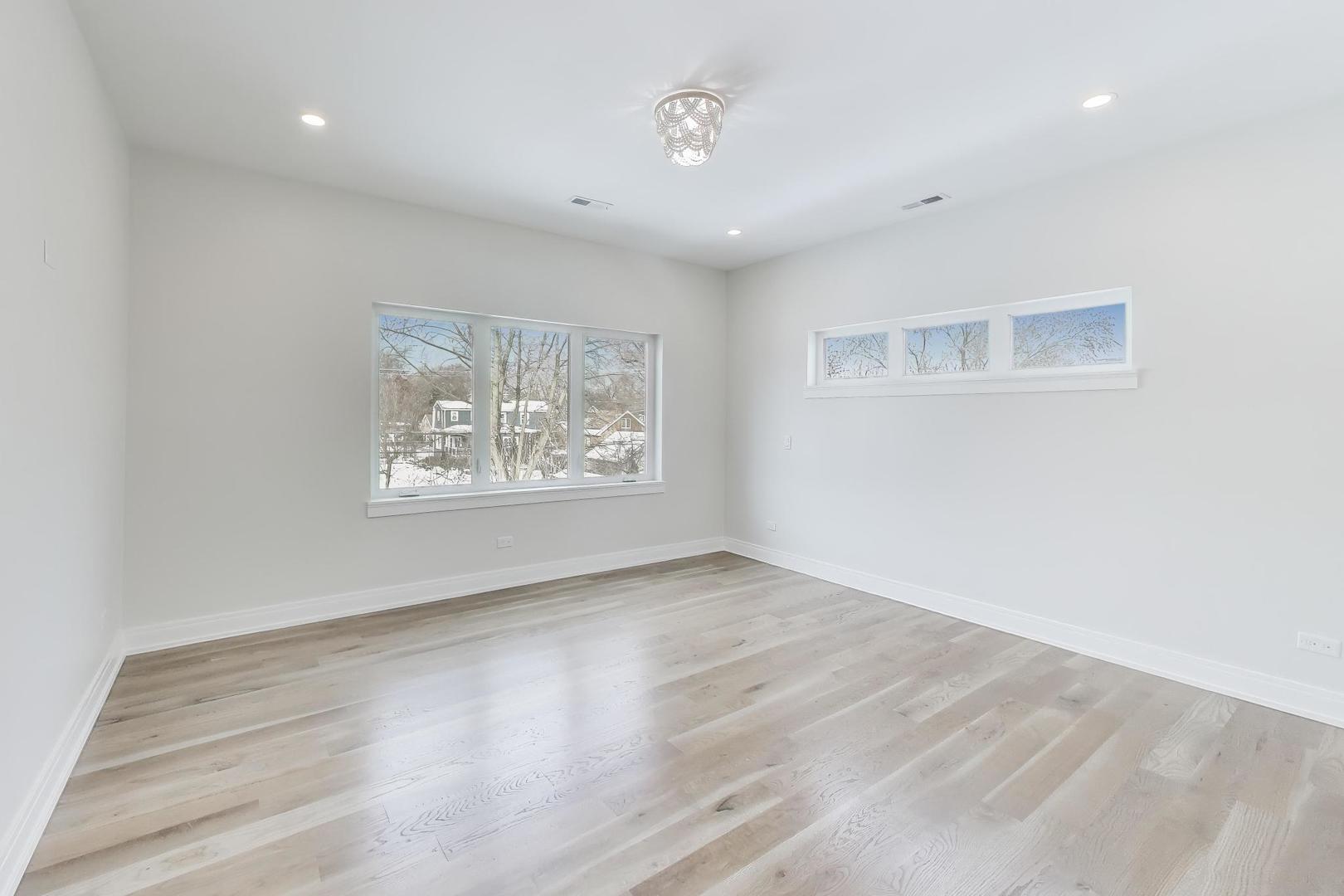 280 Blackhawk Road Riverside, IL 60546 - Photo 23 of 51 an empty room with wooden floor and window