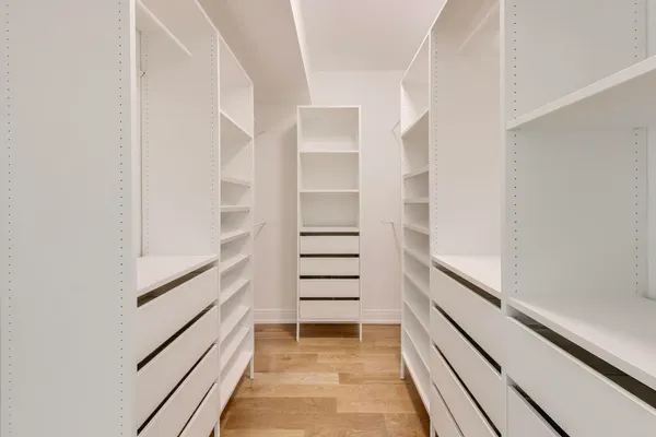 a spacious bathroom with a double vanity sink mirror and bathtub