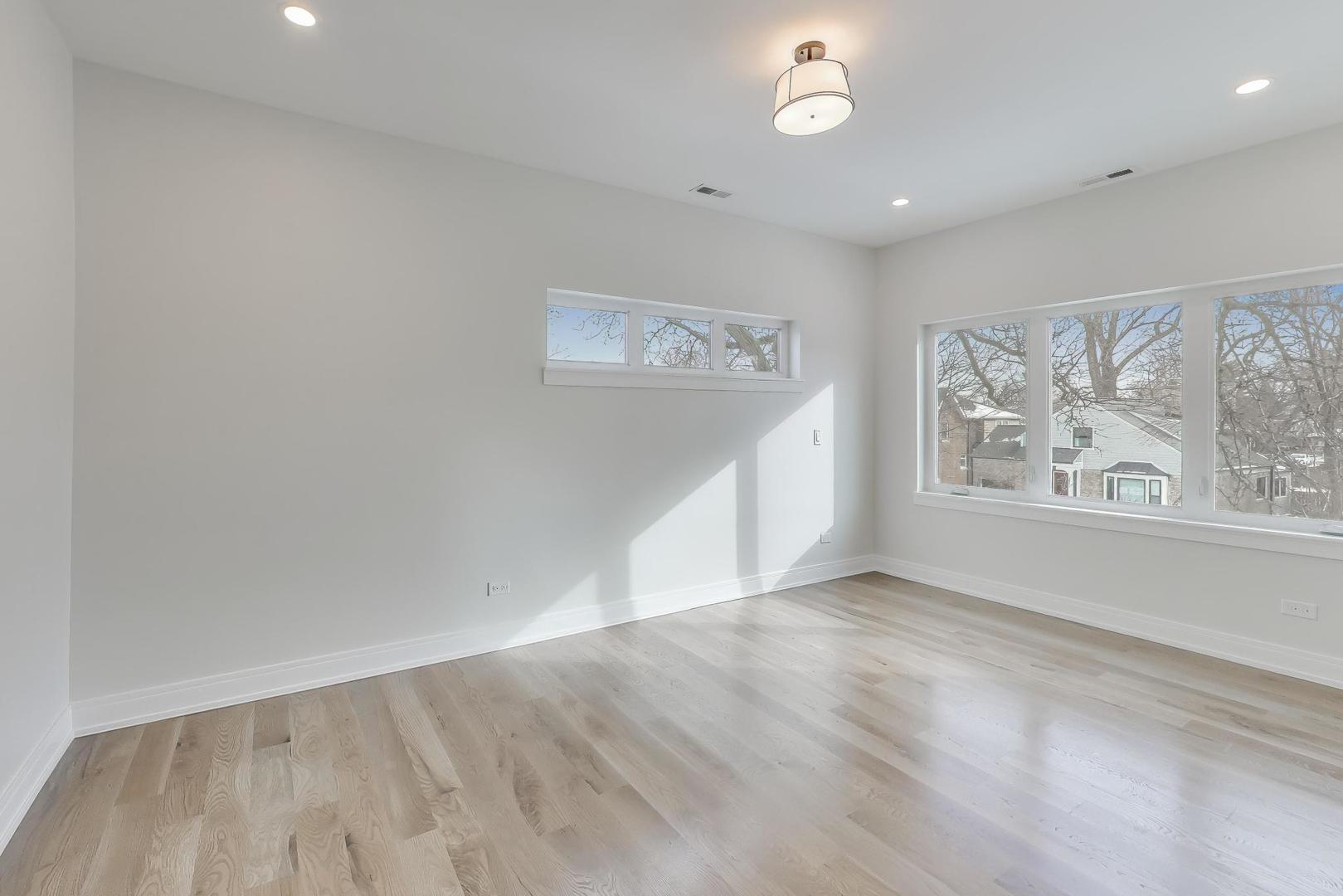 280 Blackhawk Road Riverside, IL 60546 - Photo 28 of 51 wooden floor in an empty room with a window