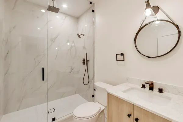 a room with furniture and white cabinets