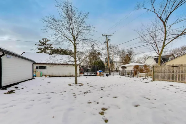 a view of a yard covered in snow
