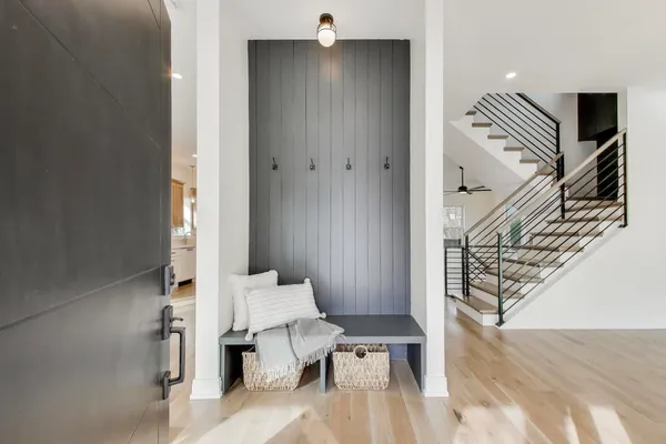 a view of entryway and hall with wooden floor