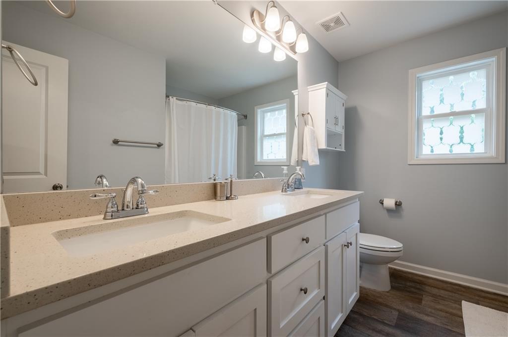 719 Fairview Road Brooks, GA 30205 - Photo 22 of 35 a bathroom with a double vanity sink toilet and a mirror