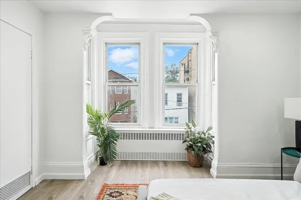 a bed room with a bed and a window