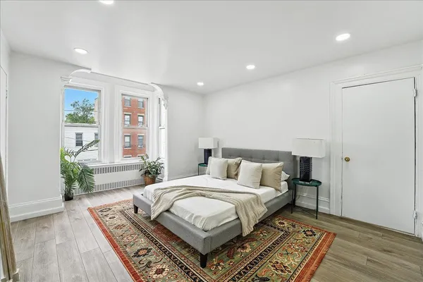 a bedroom with a large bed and a large window