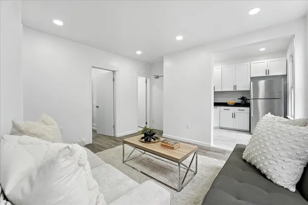 a living room with furniture and a potted plant