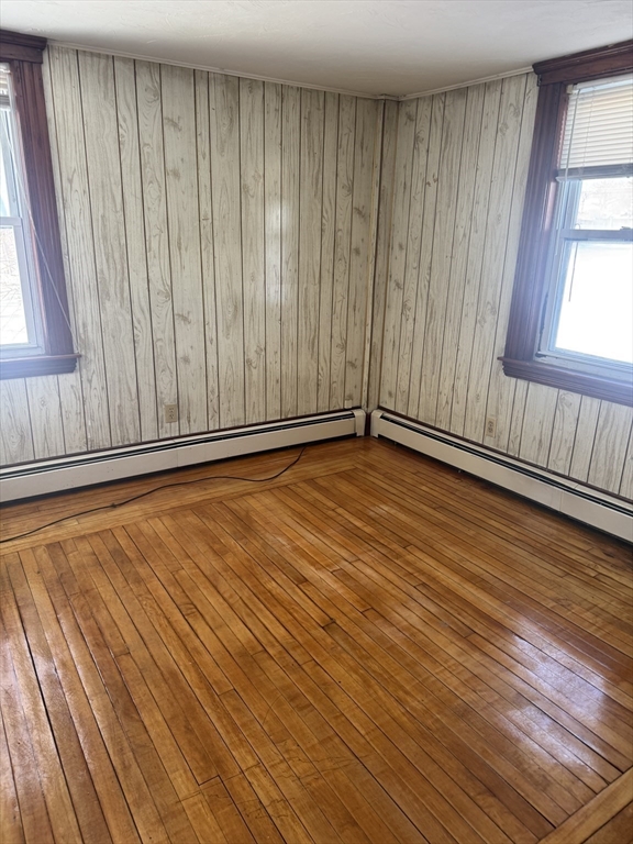 190 Medway Road, Unit A Milford, MA 01757 - Photo 2 of 7 a view of an empty room with wooden floor and a window