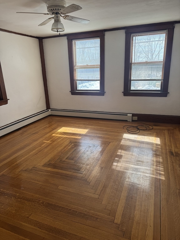 190 Medway Road, Unit A Milford, MA 01757 - Photo 3 of 7 a view of an empty room with window and wooden floor