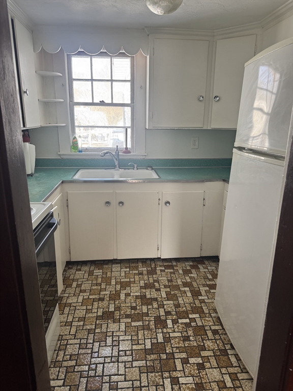 190 Medway Road, Unit A Milford, MA 01757 - Photo 6 of 7 a room with window and cabinets