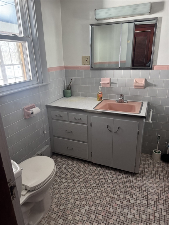 190 Medway Road, Unit A Milford, MA 01757 - Photo 7 of 7 a bathroom with a sink a toilet and mirror