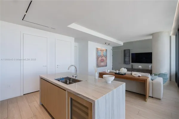 a kitchen with a sink and a stove top oven