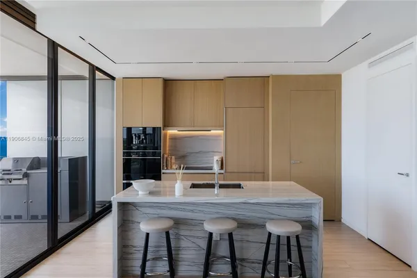 a dining table with chairs and refrigerator