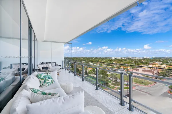a balcony with furniture and city view